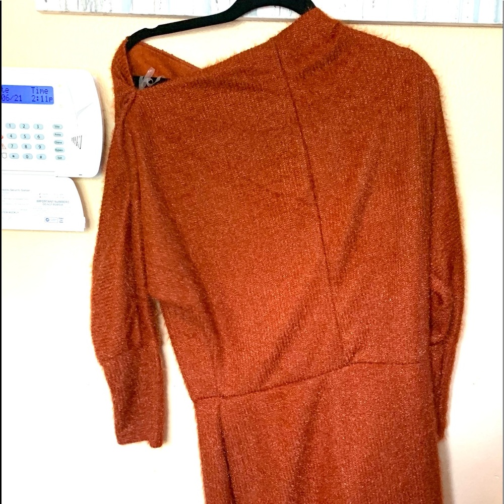 A large sweater dress. The color is orange.